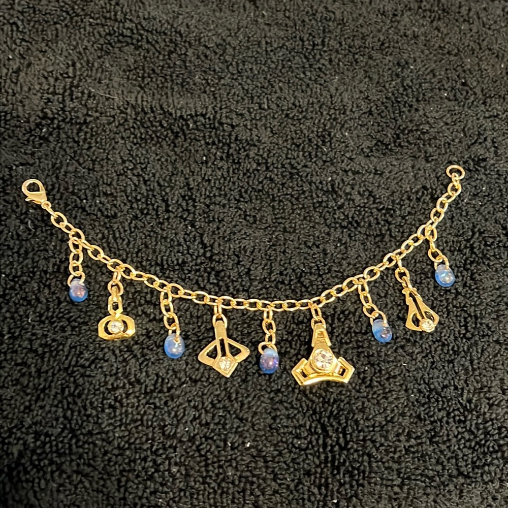 Gold tone charm bracelet with rhinestone iridescent handmade blue glass beads 8"